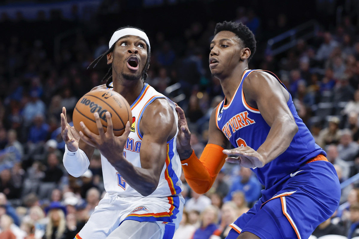 Nov 21, 2022; Oklahoma City, Oklahoma, USA; Oklahoma City Thunder guard Shai Gilgeous-Alexander (left) controls the ball against New York Knicks guard RJ Barrett (right) during the second half at Paycom Center. New York won 129-119. Mandatory Credit: Alonzo Adams-USA TODAY Sports